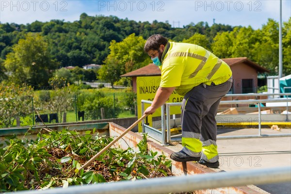 Worker in a recycling factory or clean point and garbage with a face mask and with security protections