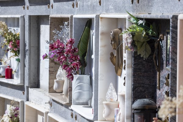 Wall with decorated urns graves in a cemetery in Sardinia