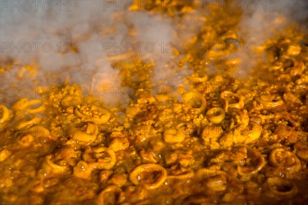 The rice at its point in the Valencian paella with embers and vegetables. Traditional Spanish food