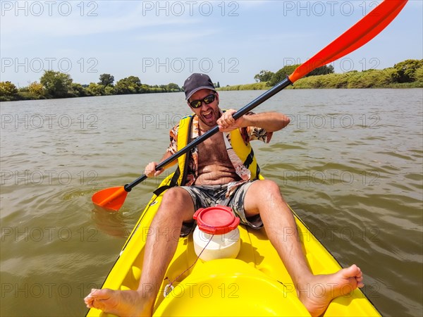 A young man in the canoe doing canoeing in the a natural park of Catalonia