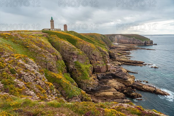 The beautiful coastline next to the Phare Du Cap Frehel is a maritime lighthouse in Cotes-dÂ´Armor France . At the tip of Cap Frehel