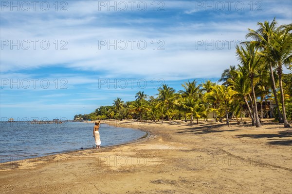 A young tourist on the beach of Sandy Bay on Roatan Island. Honduras