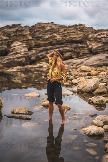 Caucasian blonde girl in a floral shirt