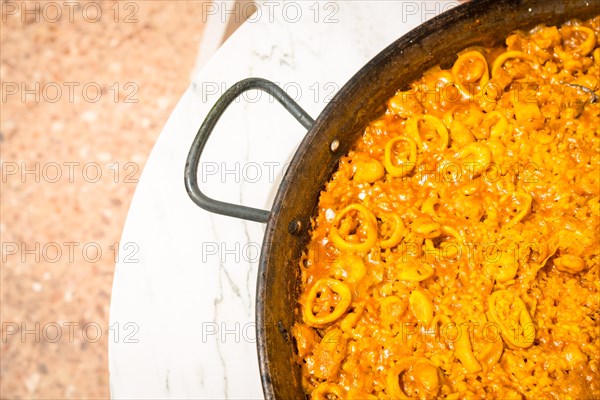 Valencian paella made on wood and vegetable embers. Traditional Spanish Mediterranean food of fish and seafood