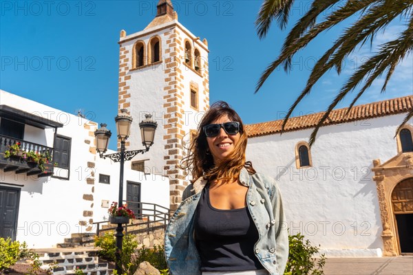 A young tourist enjoying the holidays next to the white church of Betancuria