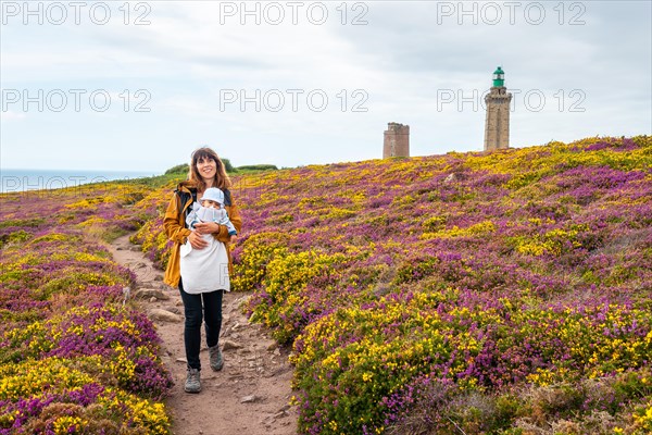 A mother next to the flowers in summer in Phare Du Cap Frehel