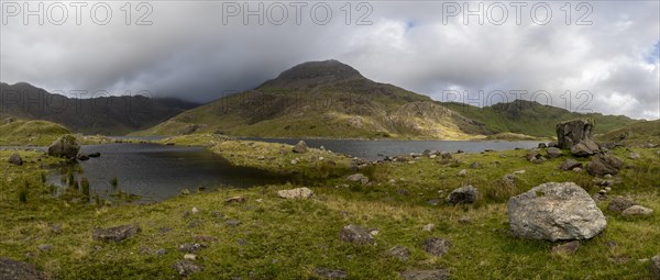 Lake Llyn Llydaw with Mount Snowdon behind clouds in late summer