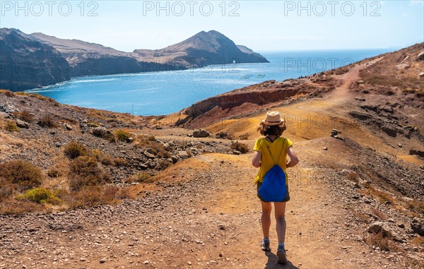 A young woman tourist on the Ponta de Sao Lourenco trail in the Baia D'Abra