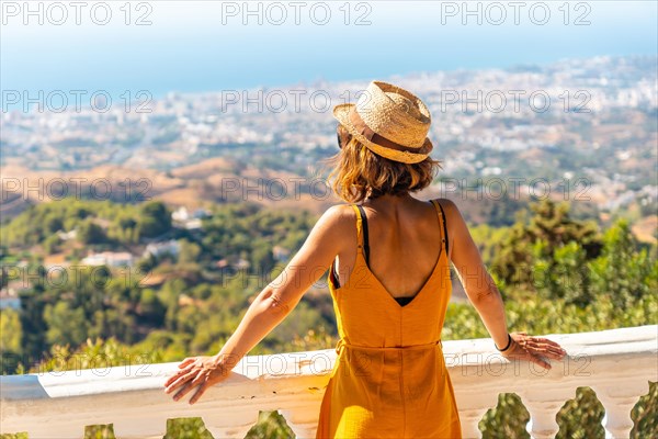 A young tourist looking from the viewpoint in the municipality of Mijas in Malaga. Andalusia