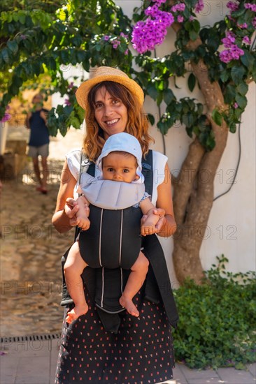 A mother walking with her baby in Sa Tuna on the coast of Begur in summer