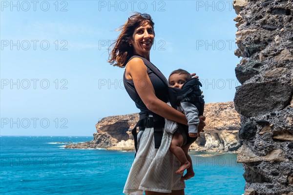 A young mother with her son in the Cuevas de Ajuy