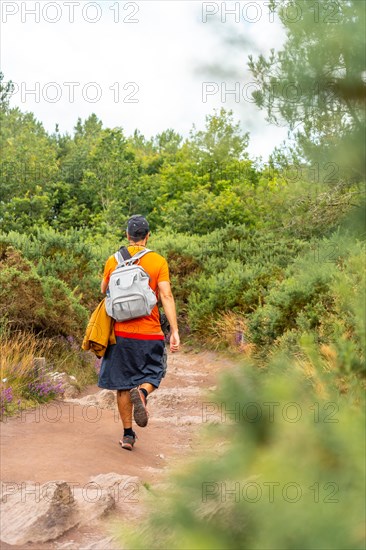 A young man on the footpath in the Broceliande forest