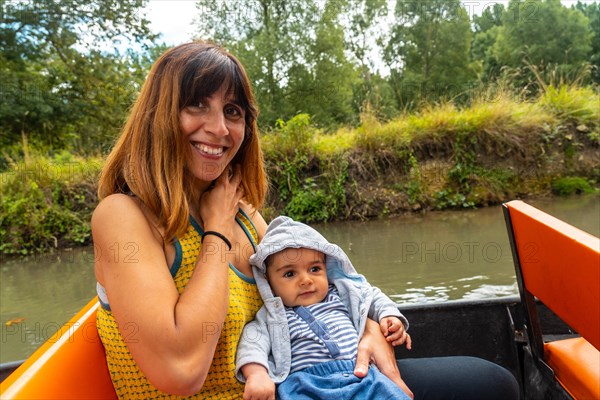 A mother with her baby on the boat sailing between La Garette and Coulon