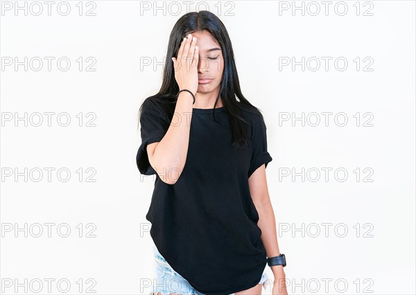 Worried young woman holding his forehead. Stressed people with palm on forehead isolated. Stressed young woman holding her forehead