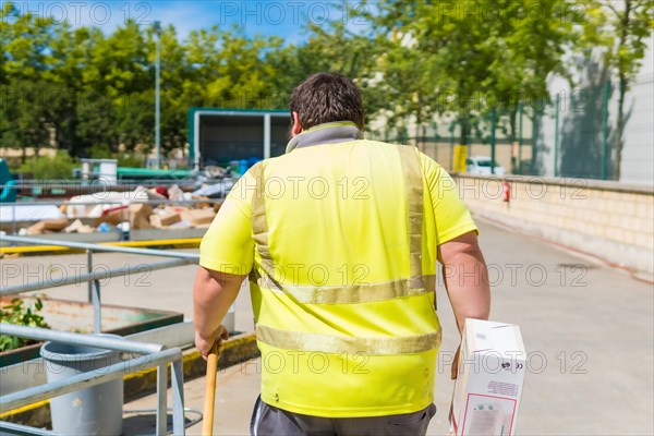 Worker in a recycling factory or clean point and garbage with a face mask and with security protections