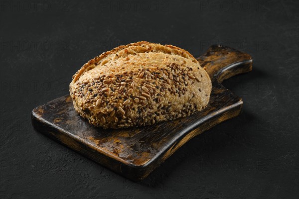 Whole loaf of artisan bread with sunflower and sesame seeds