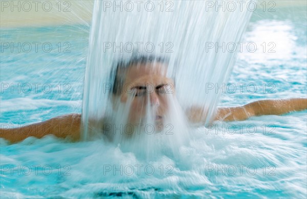 Woman Face in a Waterfall in a SPA Swimming Pool in Long Exposure in Switzerland