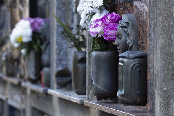 Wall with decorated urns graves in a cemetery in Sardinia