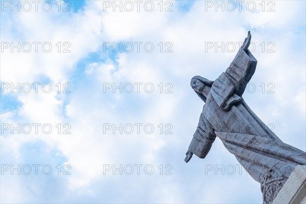 Sculpture detail of Mirador de Cristo Rei in Funchal in summer with clouds
