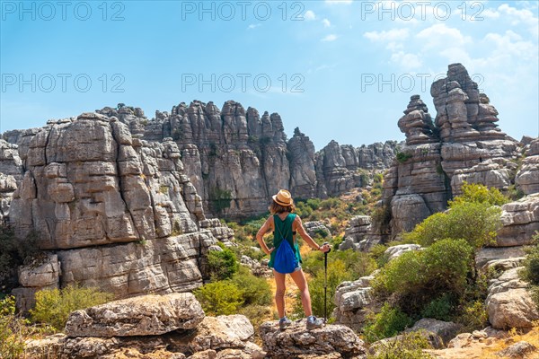 A young woman in Torcal de Antequera on the green and yellow trail enjoying freedom