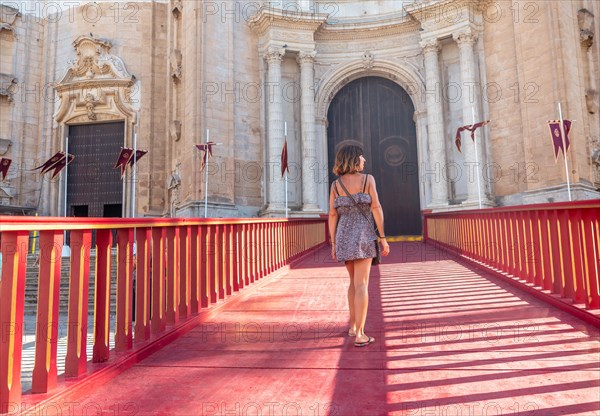 A young tourist on the red carpet of the Santa Iglesia Catedral in the city of Cadiz. Andalusia