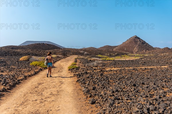 A young woman on the path to the north of the Isla de Lobos