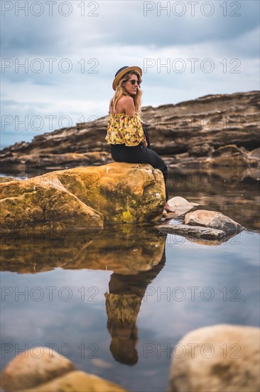 Caucasian blonde girl in a floral shirt