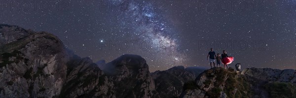 A family enjoying the night on top of a mountain with milky way. Adventure lifestyle A summer afternoon in the mountains of the Basque country