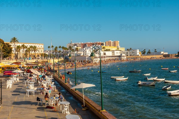 La Caleta beach full of tourism in the summer sunset of the city of Cadiz. Andalusia