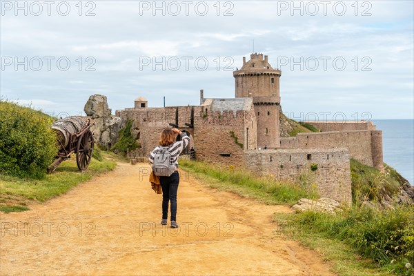 A young tourist at Fort-la-Latte castle next to Cape Frehel and near Saint-Malo