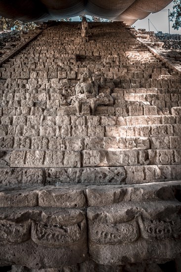 A Mayan figure on the stairs of the Copan Ruinas temples. Honduras