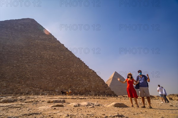 A couple in the pyramid of Cheops the largest pyramid. The pyramids of Giza the oldest funerary monument in the world. In the city of Cairo