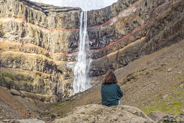 A young girl sitting in one of the wonders of Iceland