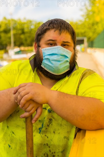 Worker in a recycling factory or clean point and garbage with a face mask and with security protections