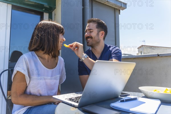 A couple confined at home making a video call with some friends with the computer