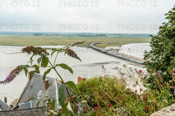 The arrival trail to the famous Mont Saint-Michel Abbey at high tide in the Manche department