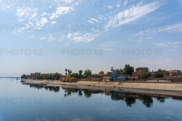 Traditional Egyptian villages on the bank of the river Nile. Views sailing on the cruise on the river Nile from Luxor to Aswer