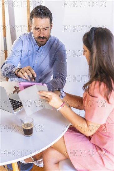 A couple teleworking at home