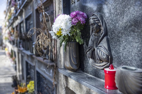 Wall with decorated urns graves in a cemetery in Sardinia