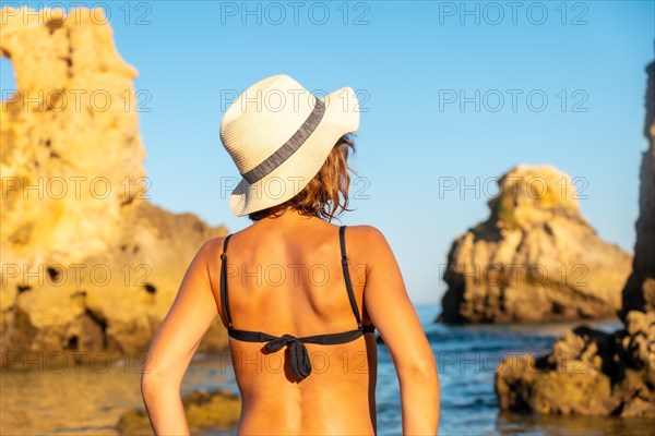 A woman enjoying the summer at Praia dos Arrifes