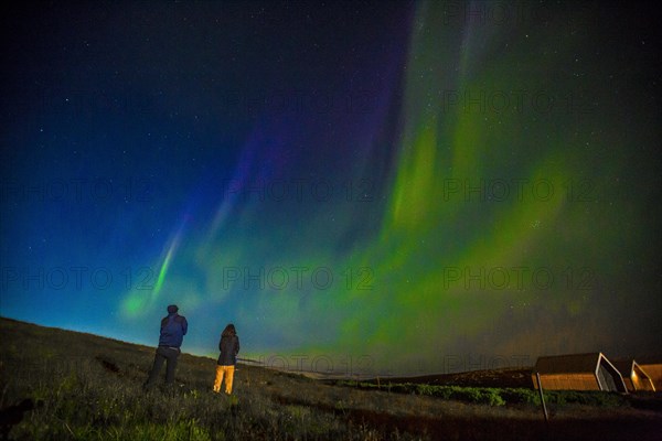 A couple in Northern lights in the sky on the Reykjanes peninsula in southern Iceland