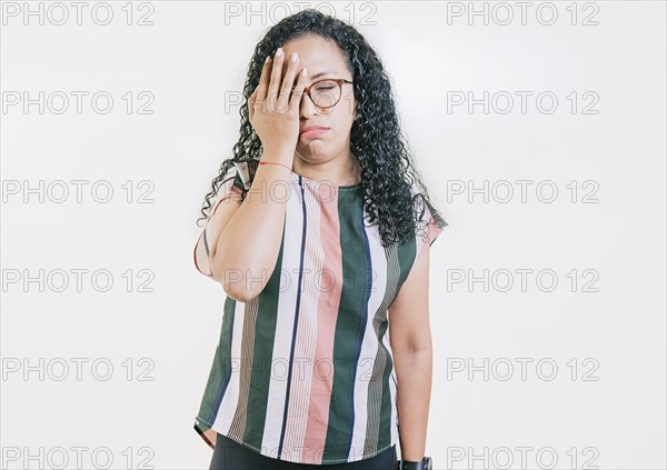 Worried young woman holding his forehead. Stressed young woman holding her forehead. Stressed people with palm on forehead isolated