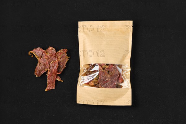Top view of dehydrated lamb jerky meat in paper package