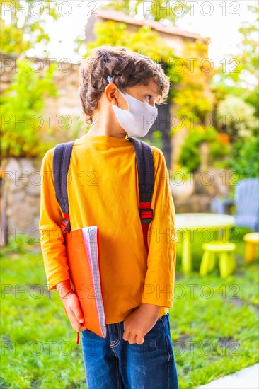 Caucasian child with face mask ready for back to school. New normality