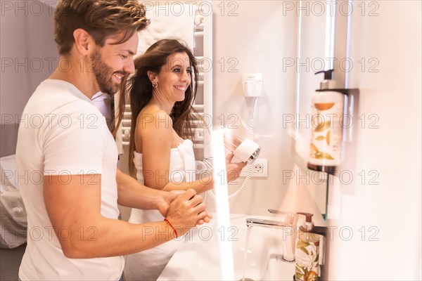 A newly awakened couple in pajamas preparing to go out in the toilet