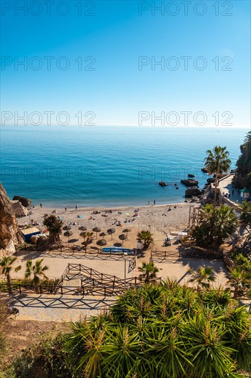 Calahonda beach in the town of Nerja with people sunbathing in spring