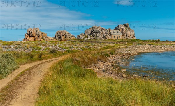 Path to the house among rocks by the sea