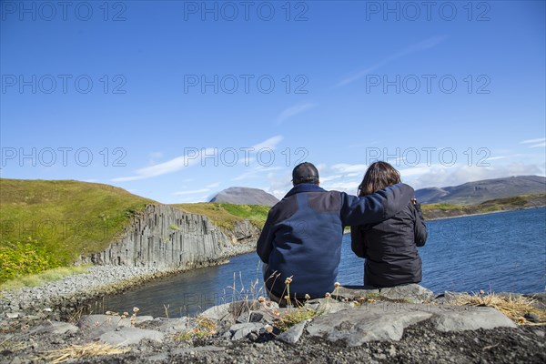 A couple in spectacular shape in the stones on the beach of Olafsfjordur. Iceland