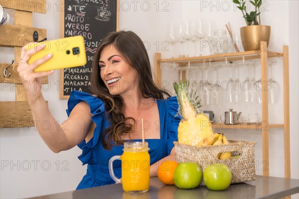 Woman taking a selfie in a cafeteria counter with healthy fruit and juices