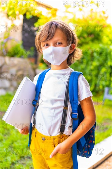 Caucasian child with face mask ready for back to school. New normality